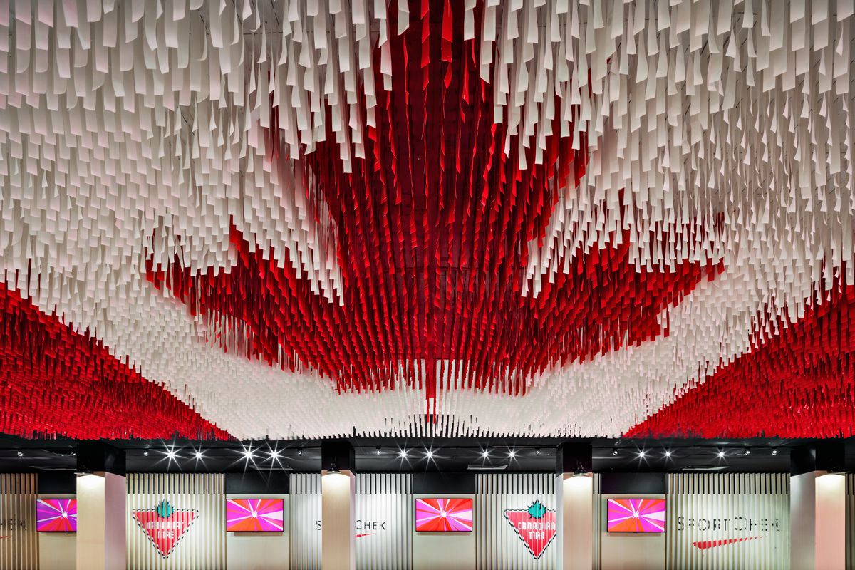 This deconstructed Canadian flag is made up of hundreds of hanging ribbons and is suspended from the ceiling of the Celebration Lounge.