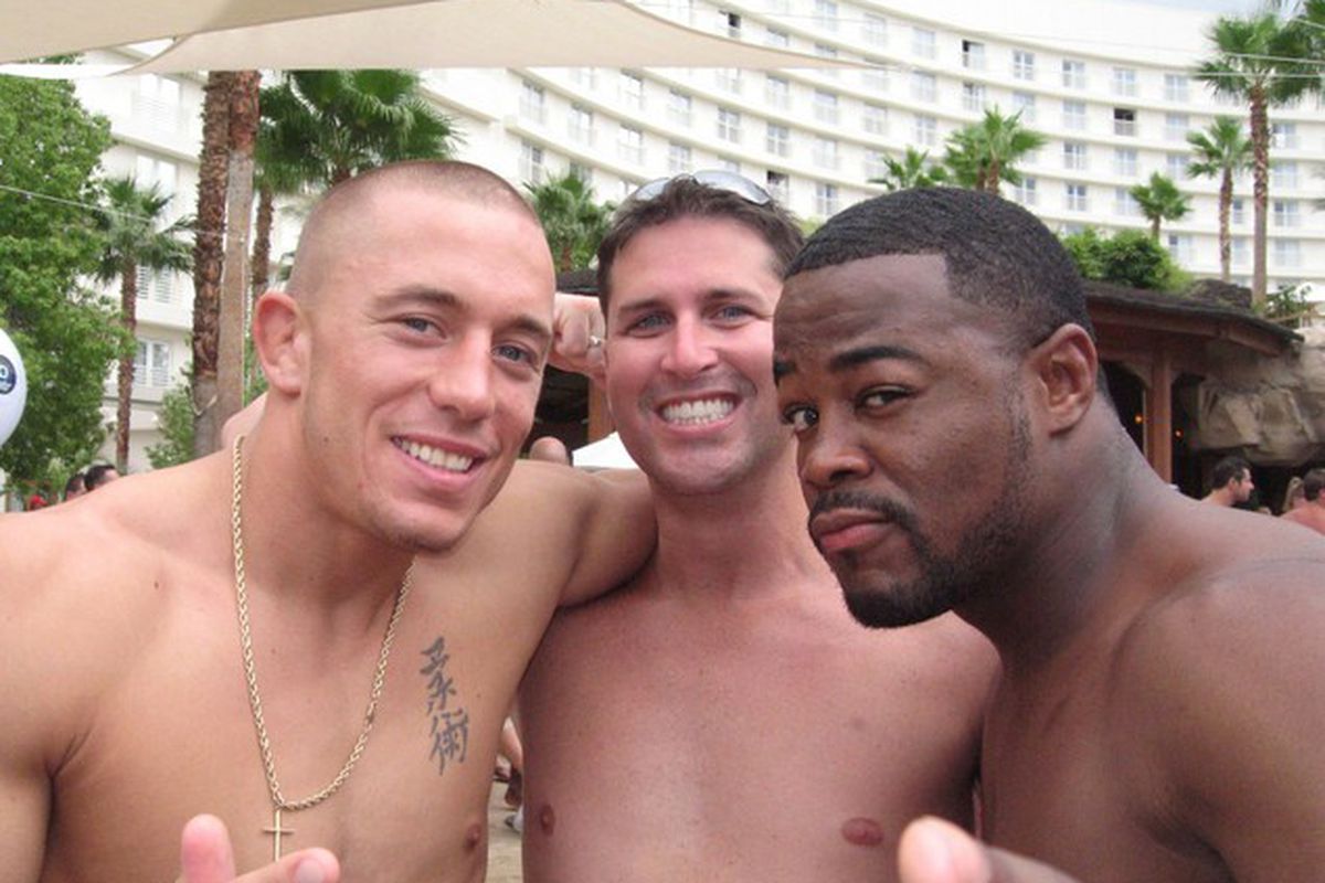 No idea who the man in the middle is, but he doesn't seem to be complaining about the newly cautious fighting styles of Georges St Pierre and Rashad Evans.