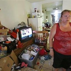 In this Tuesday, April 8, 2014 photo, Theresa Muller prepares to move out of her motel room she shares with her boyfriend, father and three children in Kissimmee, Fla.   Muller and her family have been homeless but plan to move to a home in a neighboring county. 