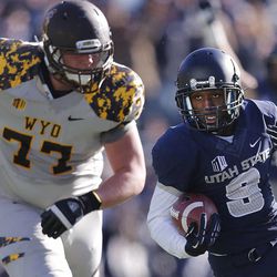 USU's Bruce Natson returns a punt for a touchdown as Utah State and Wyoming play Saturday, Nov. 30, 2013, in Logan. USU won, 35-7.