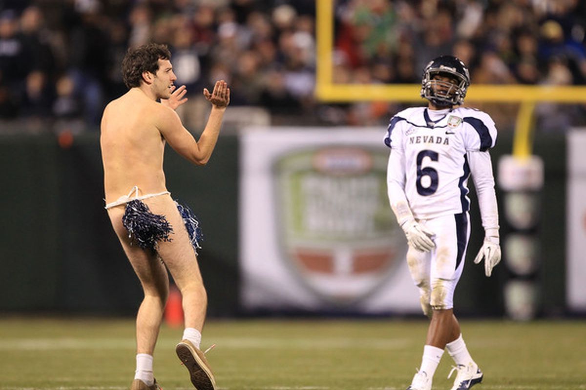 A streaker runs on to the field in front of Doyle Miller #6 of the Nevada Wolf Pack during their game against Boston College in the Kraft Fight Hunger Bowl at AT&T Park on January 9 2011 in San Francisco California.  (Photo by Ezra Shaw/Getty Images)