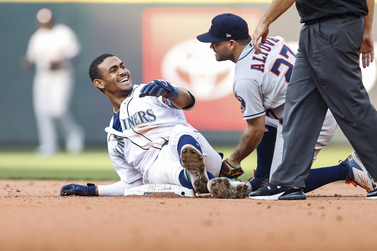 Julio Rodriguez #44 of the Seattle Mariners slides into second and Jose Altuve #27 of the Houston Astros for a double during the eighth inning in game three of the American League Division Series at T-Mobile Park on October 15, 2022 in Seattle, Washington.