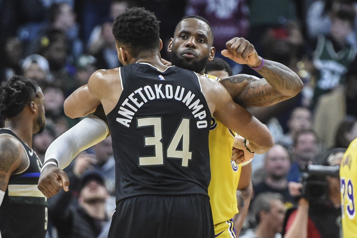 Milwaukee Bucks forward Giannis Antetokounmpo gives Los Angeles Lakers forward LeBron James a hug after a game at Fiserv Forum.