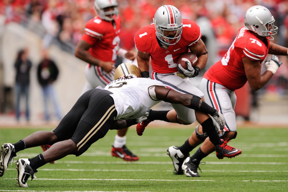 COLUMBUS OH - OCTOBER 23:  Dan Herron #1 of the Ohio State Buckeyes attempts to leap over the tackle attempt of Dwayne Beckford #3 of the Purdue Boilermakers at Ohio Stadium on October 23 2010 in Columbus Ohio.  (Photo by Jamie Sabau/Getty Images)