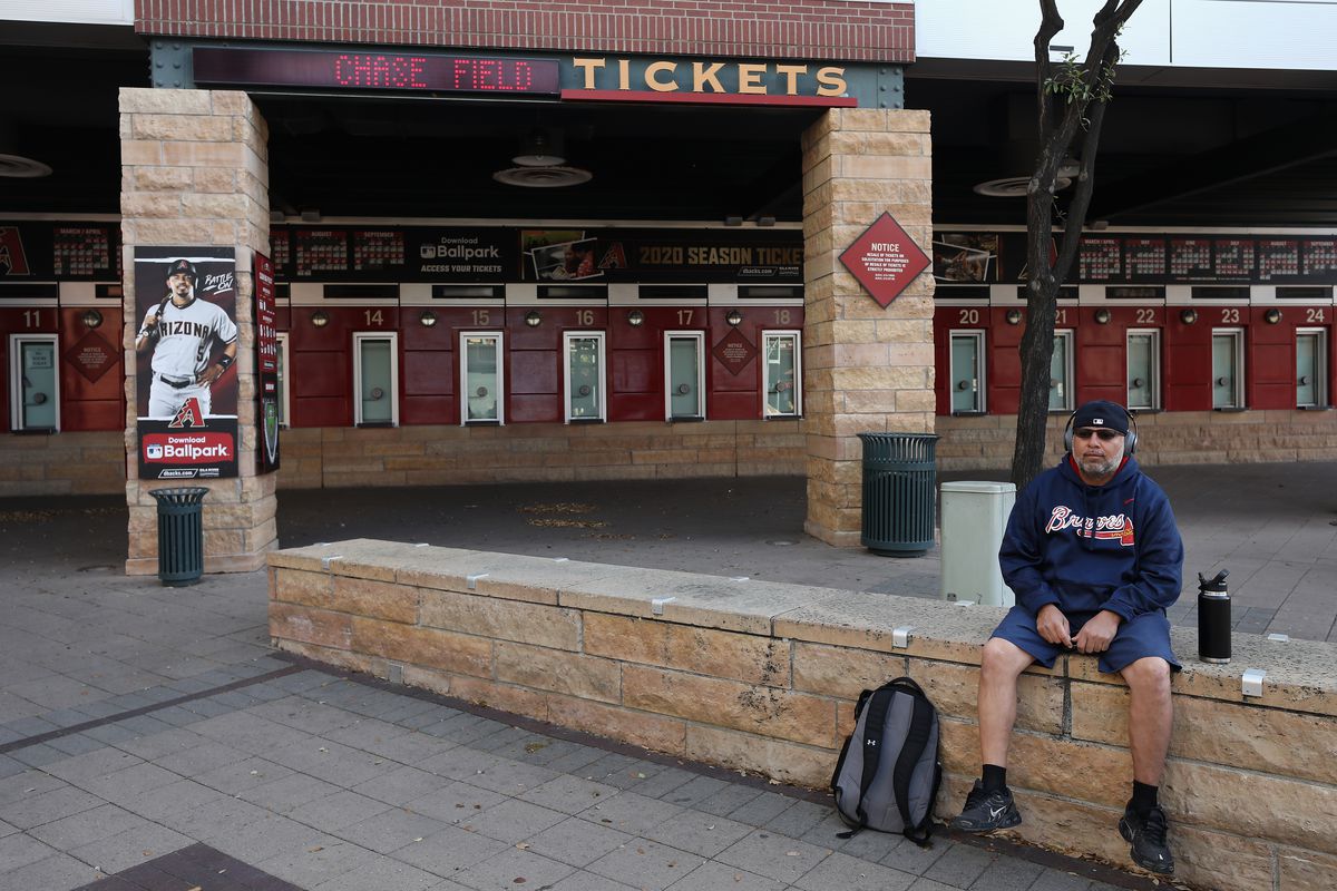 The closed ticket windows at Chase Field, with a single, lonely Braves fan sitting on the far right of the fame, probably waiting for spring like the rest of us.