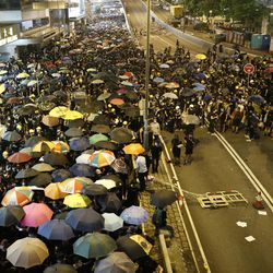 Protesters move along a street in Hong Kong on Sunday, July 21, 2019. Protesters in Hong Kong pressed on Sunday past the designated end point for a march in which tens of thousands repeated demands for direct elections in the Chinese territory and an independent investigation into police tactics used in previous demonstrations. (AP Photo/Vincent Yu)