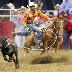 Cory Solomon of Prairie View Texas, competes in the Tie down roping during the final night of competition Saturday, July 25, 2015, of the Days of 47 Rodeo at EnergySolutions Arena in Salt Lake City.