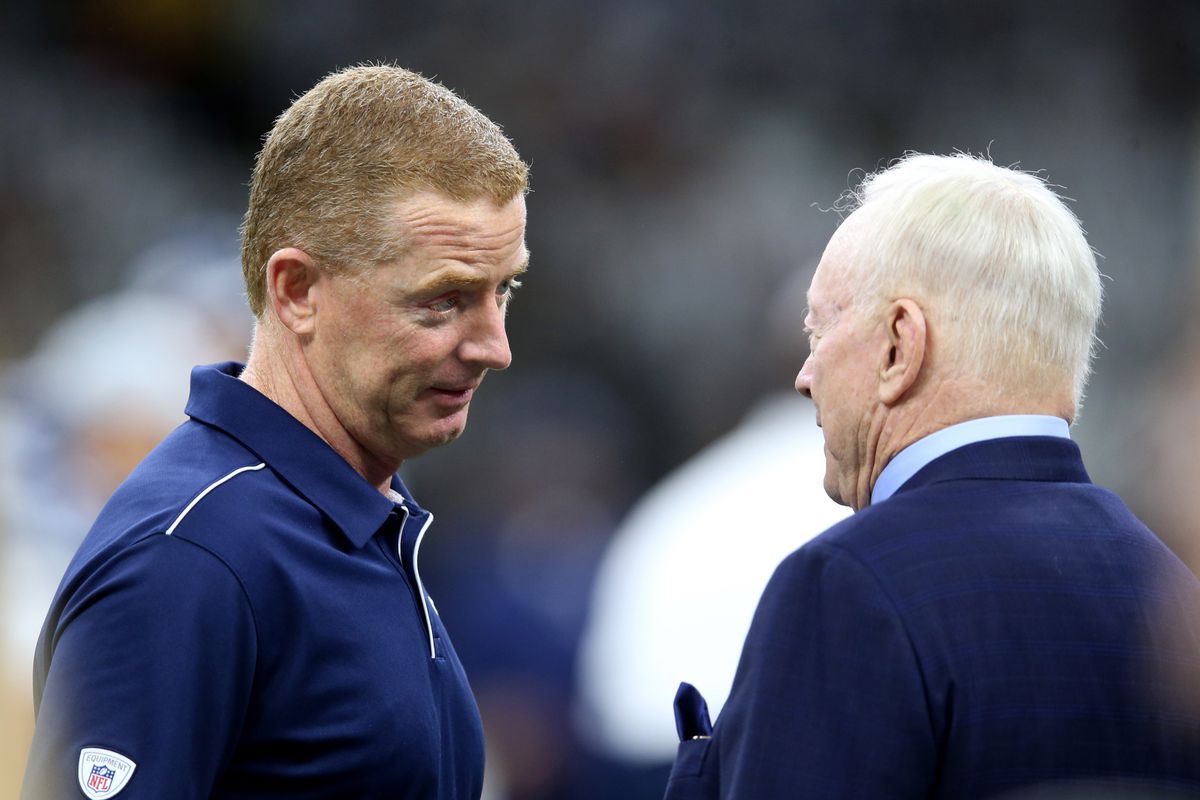 Dallas Cowboys head coach Jason Garrett talks to team owner Jerry Jones before their game against the New Orleans Saints at the Mercedes-Benz Superdome.