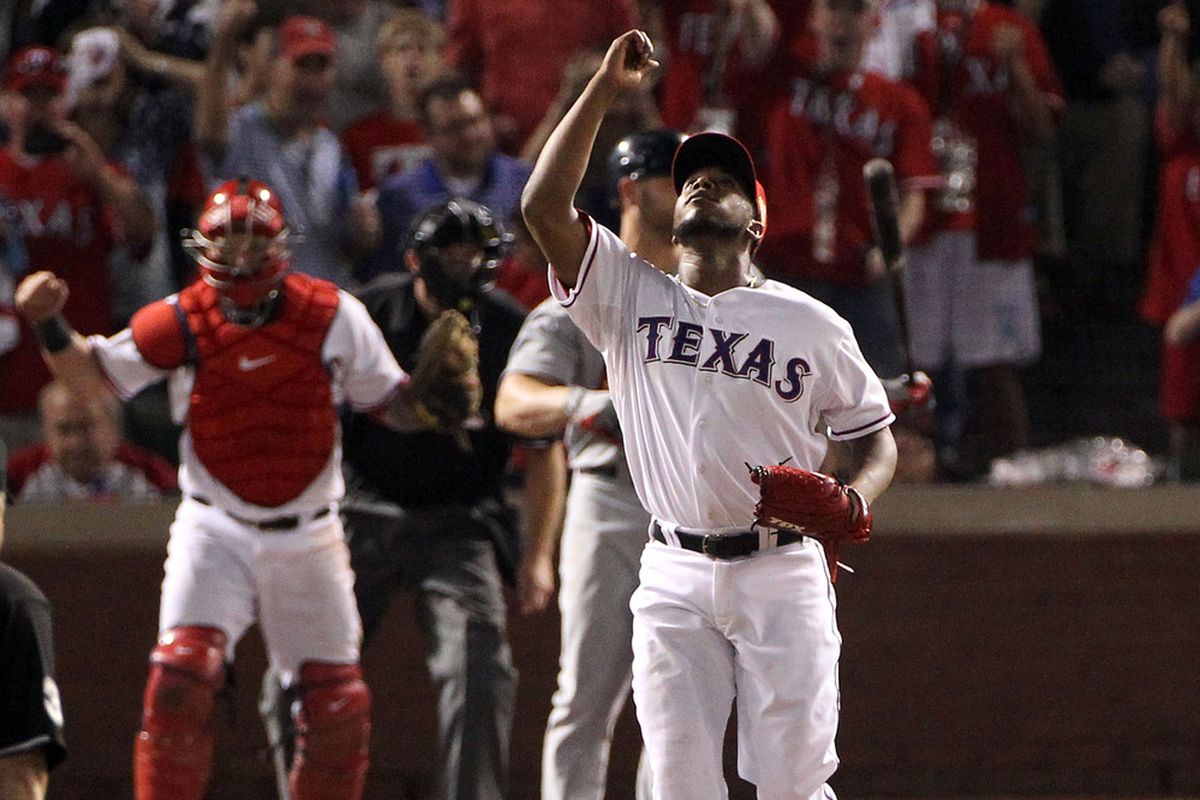 ARLINGTON, TX - OCTOBER 23: Neftali Feliz #30 of the Texas Rangers celebrates after learning of the new SBNation iPhone app.  (Photo by Ezra Shaw/Getty Images)
