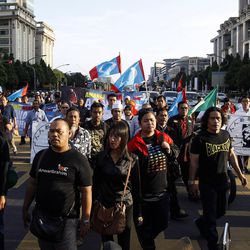 Supporters of Malaysian opposition leader Anwar Ibrahim march towards the Palace of Justice at Putrajaya, Malaysia, Tuesday, Feb. 10, 2015. Malaysia's top court has rejected a final appeal from Anwar and sent him back to jail in a case seen at home and aboard as politically motivated to eliminate any threats to the government. 