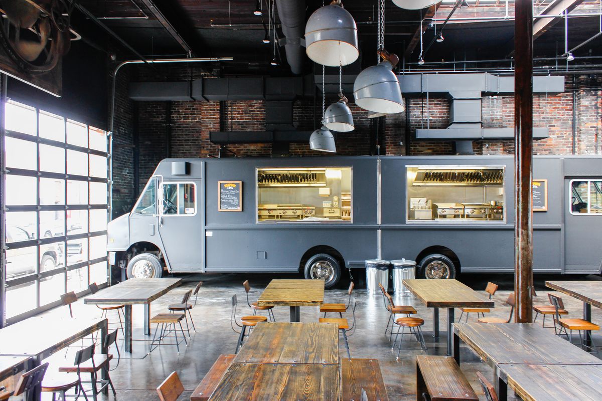 A food truck sits inside of Coppersmith in Boston, which is a bar, restaurant, and event space built into a former copper foundry.