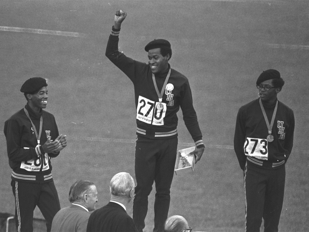 Lee Evans, center, the record-setting sprinter who wore a black beret in a sign of protest at the 1968 Olympics, died Wednesday. He was 74. 