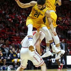 Utah Utes forward David Collette (13) holds the ball as California Golden Bears guard Nick Hamilton (21) and forward Justice Sueing (10) take flight at the Huntsman Center in Salt Lake City on Saturday, Feb. 10, 2018.