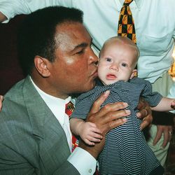 Muhammad Ali kisses Carson Whitlock, grandson to Orrin Hatch, prior to program at the Capitol Theatre.