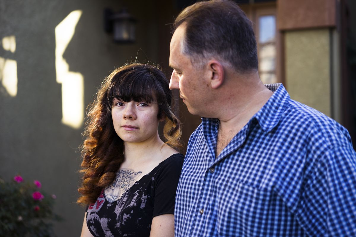 Emilie Cote with her father Michel outside their home in Gilroy, California.