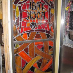 A custom-made Thai Rock stained glass survived the storm thanks to plywood