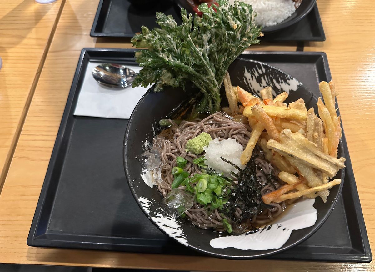 Lotus tempura and soba noodles in a bowl at Abiko Curry, a restaurant in Palisades Park.