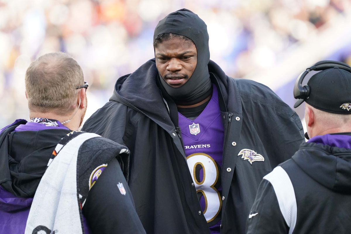 Baltimore Ravens quarterback Lamar Jackson (8) talks with team staff on the sideline in the second quarter after being sacked against the Denver Broncos at M&amp;T Bank Stadium.
