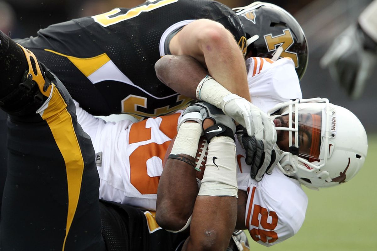 COLUMBIA, MO - NOVEMBER 12:  D.J. Monroe #26 of the Texas Longhorns is tackled by the Missouri Tigers defense during the game on November 12, 2011 at Faurot Field/Memorial Stadium in Columbia, Missouri.  (Photo by Jamie Squire/Getty Images)