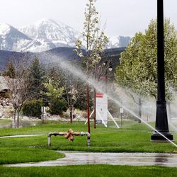 Water shoots out of sprinklers in Herriman on Tuesday, April 18, 2017. The Utah Division of Water Resources is urging people to be water-wise and refrain from landscape watering at this point.