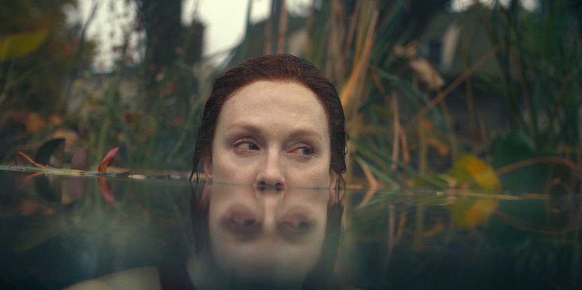 Julianne Moore, submerged in water up to her nostrils, in front of a wild jungle background in Lisey’s Story