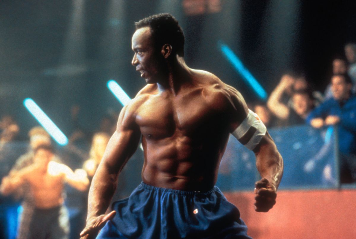 A shirtless Billy Blanks is extremely ripped and in a fighting stance in Showdown