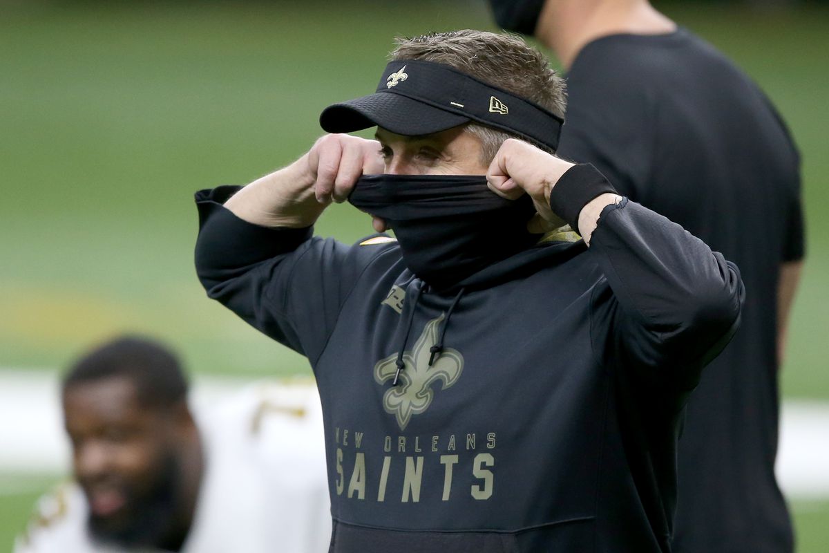 New Orleans Saints head coach Sean Payton adjusts his mask before their game against the Minnesota Vikings at the Mercedes-Benz Superdome.