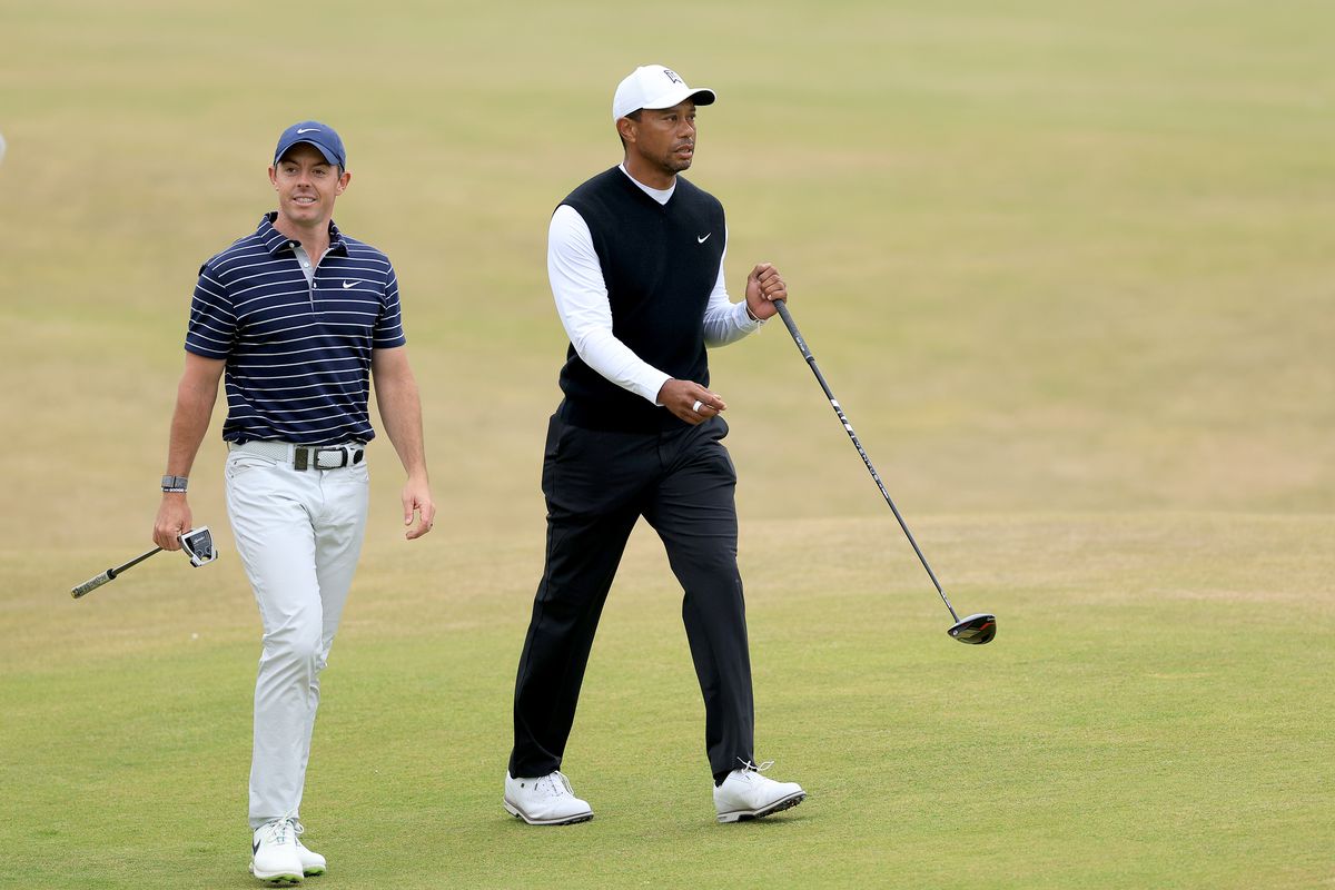 Tiger Woods of The United States with Rory McIlroy of Norther Ireland during the Celebration of Champions prior to The 150th Open at St Andrews Old Course on July 11, 2022 in St Andrews, Scotland.