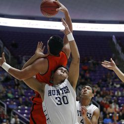 Hunter's Lorenzo Fauatea (30) reaches for a rebound against Brighton's Osa Masina (52) in the 5A boys state basketball quarterfinals at the Dee Events Center in Ogden Wednesday, Feb. 25, 2015. Brighton held on for the 65-56 victory.