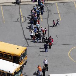 Families wait to pick up their students at a church as the Davis County Bomb Squad investigates a suspicious package at Mountain View Elementary School in Layton Monday, April 22, 2013.