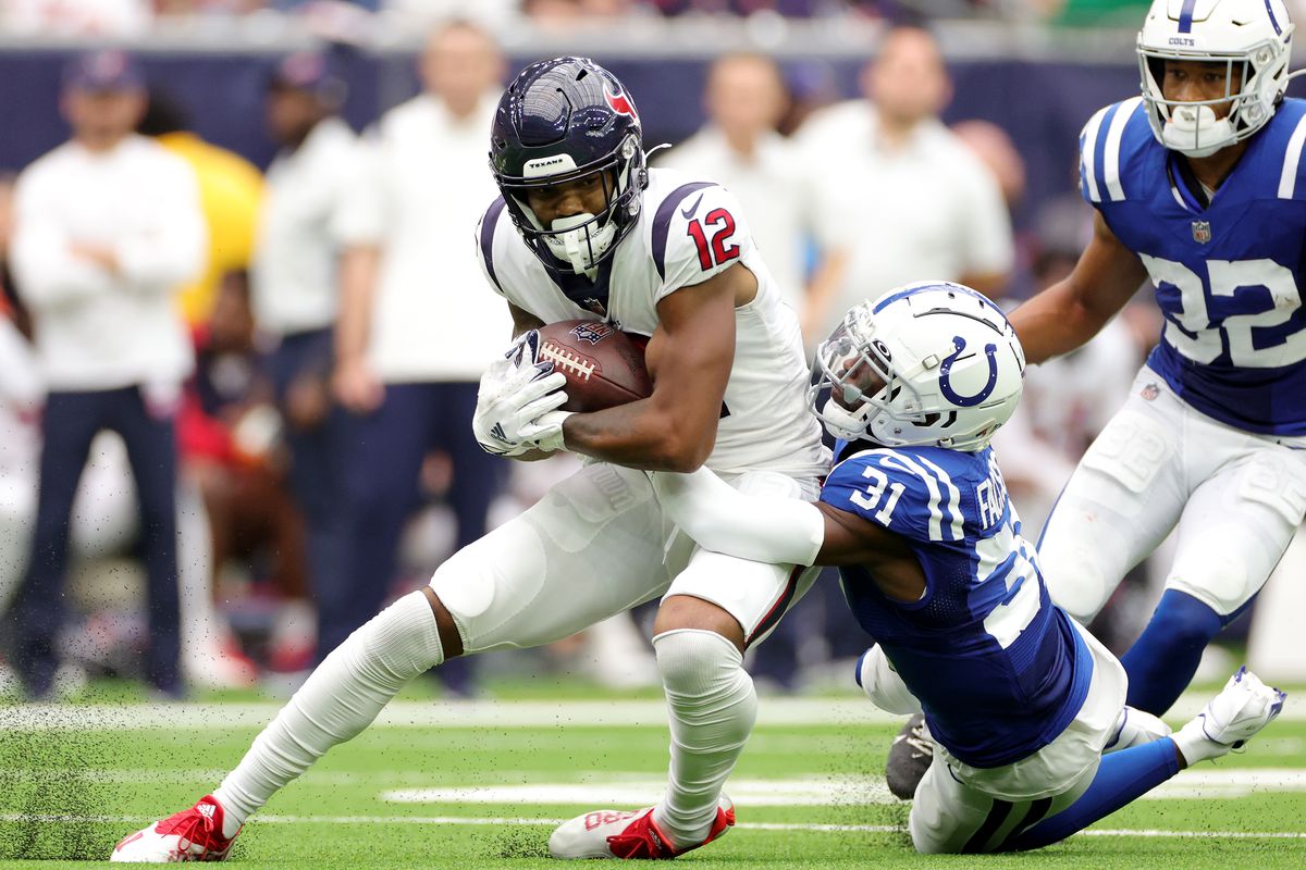 HOUSTON, TEXAS - SEPTEMBER 11: Brandon Facyson #31 of the Indianapolis Colts tackles Nico Collins #12 of the Houston Texans during the second quarter at NRG Stadium on September 11, 2022 in Houston, Texas.