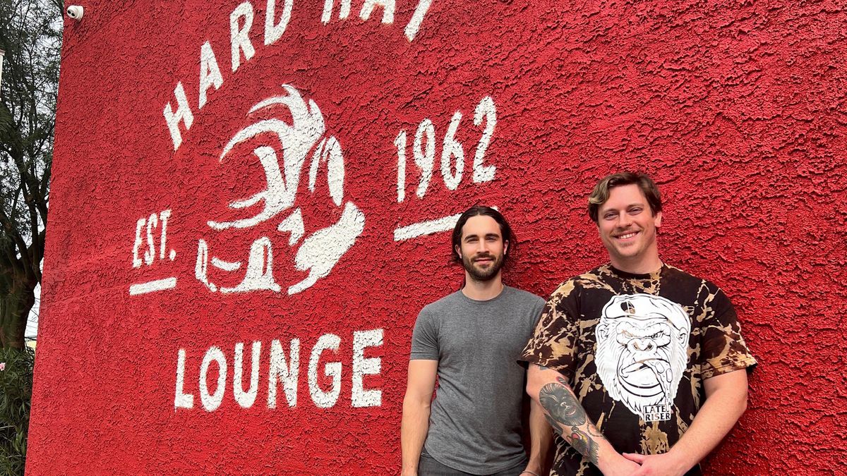 Robby Cunningham and Frank Sidoris pose in front of Hard Hat Lounge.