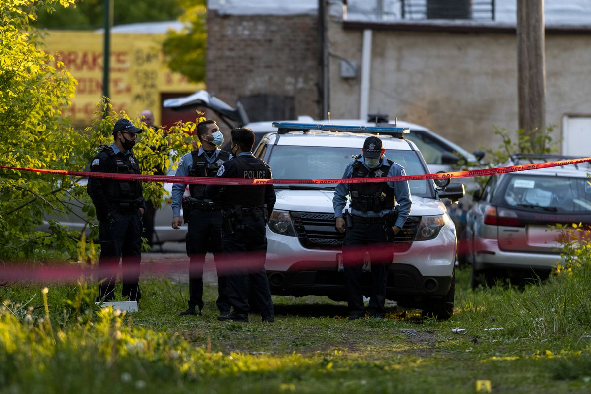 Chicago police work a crime scene where a 15-year-old boy was shot in an empty lot in the 7100 block of S Emerald Ave., in the Englewood neighborhood. Monday May 10, 2021. | Tyler LaRiviere/Sun-Time