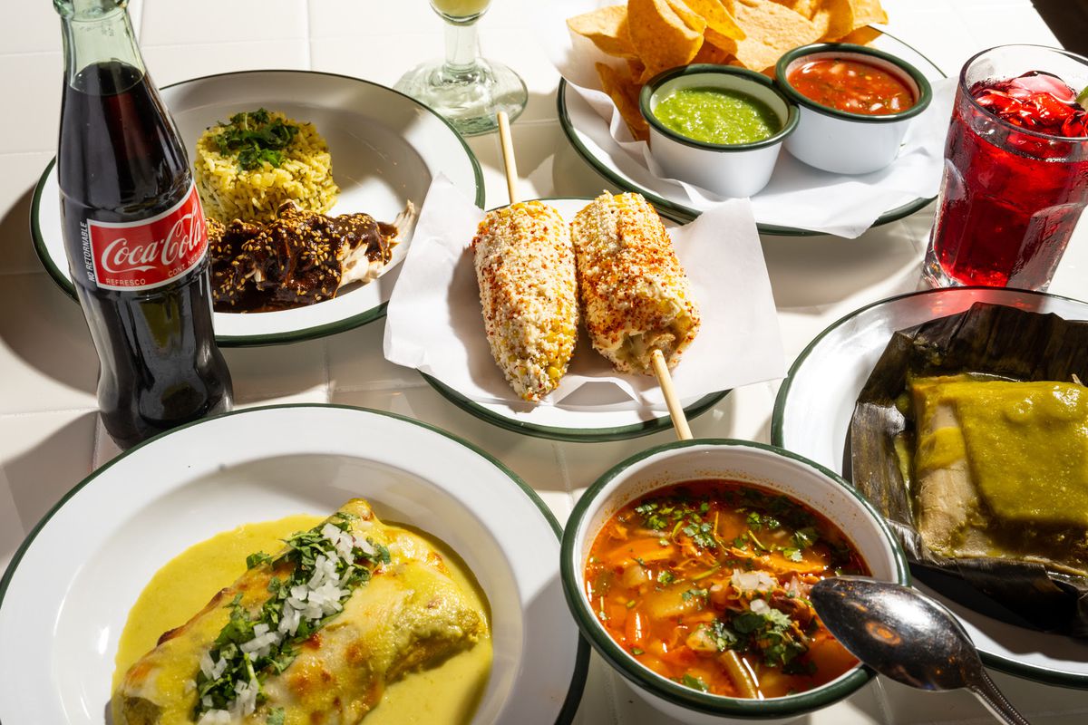 A spread of enchiladas, elote, rice and beans, caldo de pollo, and chips and salsa from Mexican restaurant Pachengo’s in Atlanta. 