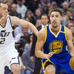 Golden State guard Klay Thompson (11) eyes the basket as Utah forward Joe Ingles (2) applies pressure during the second half of an NBA basketball game in Salt Lake City on Thursday, Dec. 8, 2016. Golden State defeated Utah with a final score of 106-99.