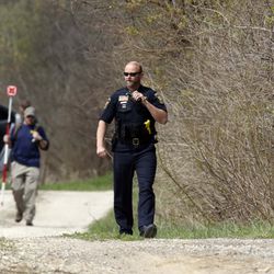 McHenry County Sheriff’s officers and other law enforcement search the area of Route 176 and Dean Street south of Woodstock, Wednesday morning. This is related to the missing Crystal Lake boy. | Brian Hill/Daily Herald