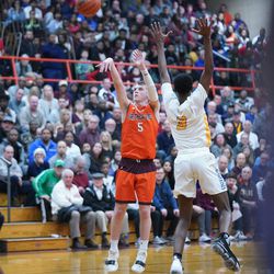 Brother Rice’s Jimmy Gaven (5) takes a three point shot over Simeon’s Antonio Reeves (3), Friday 03-01-19. Worsom Robinson/For Sun-Times