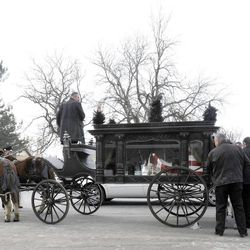 Pallbearers unload the casket for Utah County Sheriff's Sgt. Cory Wride and load it onto the horse-drawn carriage that carried it through the Spanish Fork City Cemetery on Wednesday, Feb. 5, 2014.