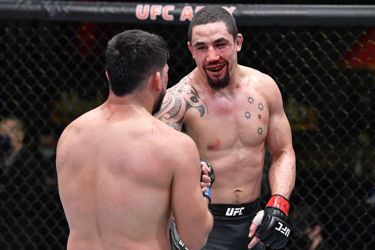 Robert Whittaker of Australia and Kelvin Gastelum talk after the conclusion of their middleweight fight during the UFC Fight Night event at UFC APEX on April 17, 2021 in Las Vegas, Nevada.