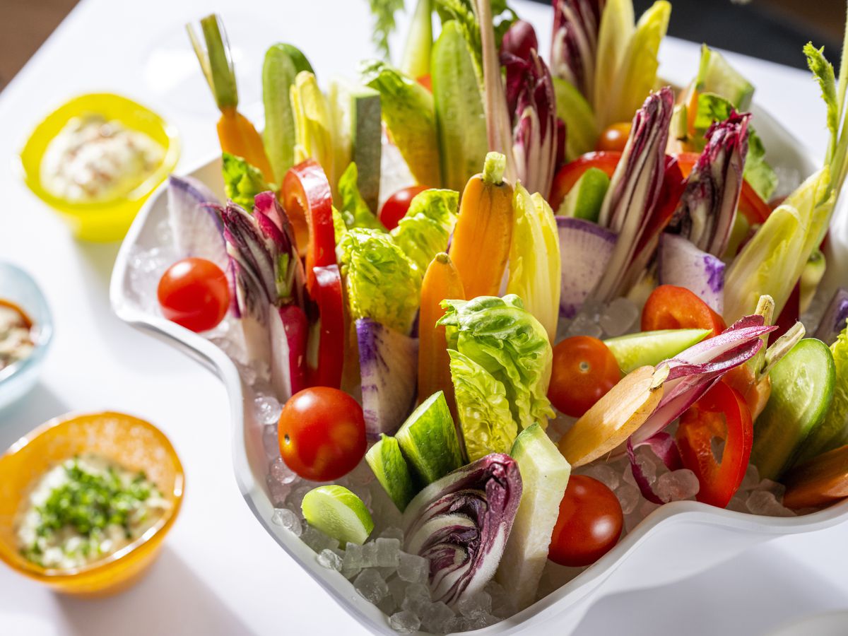 Colorful crudite with three dipping sauces. 