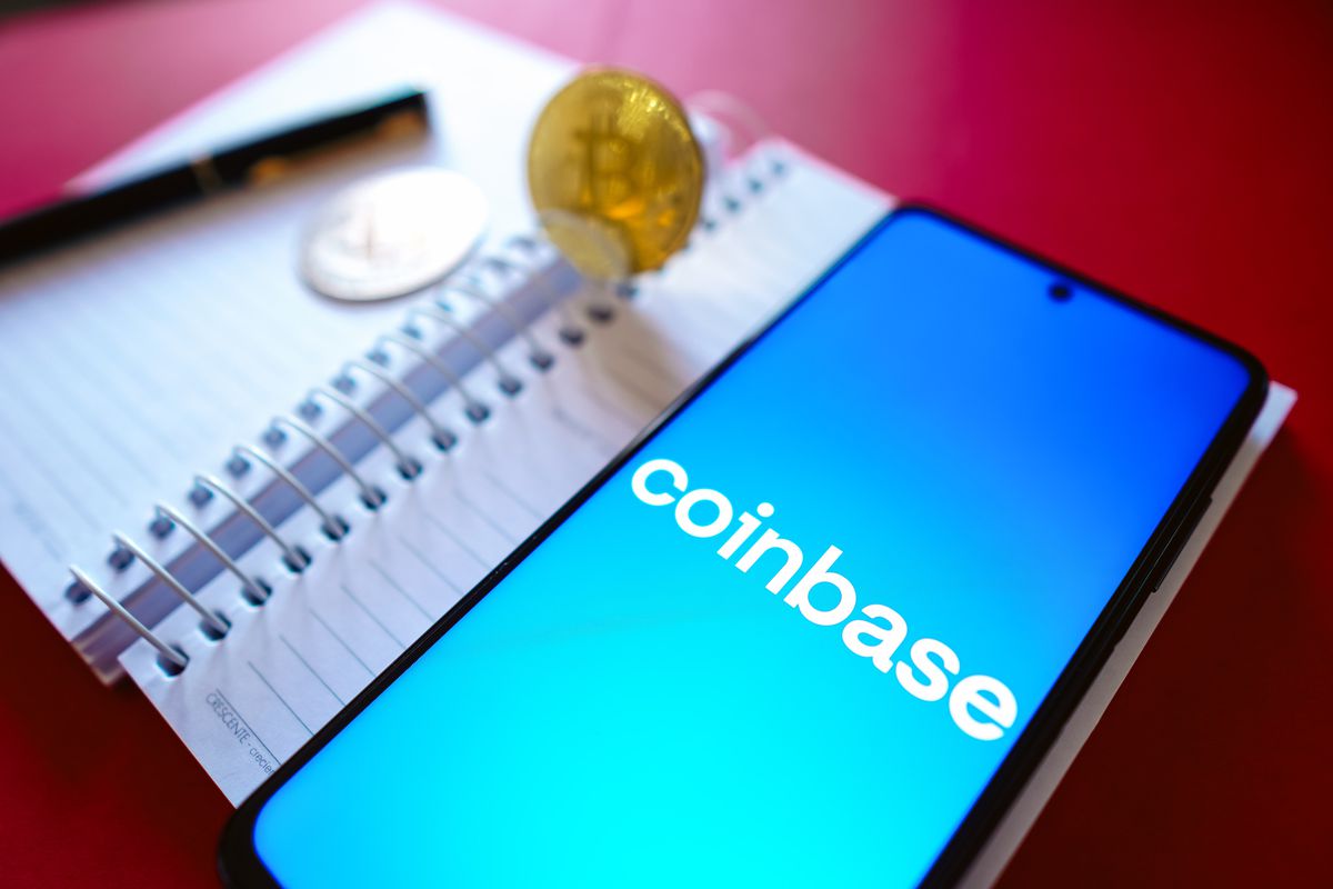 In this photo illustration, the Coinbase logo is displayed...