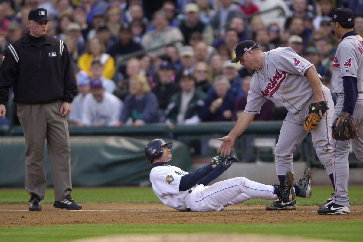 Jim Thome helps Ichiro up off the ground after a play
