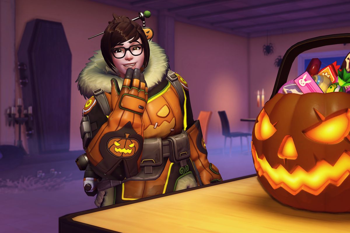 Overwatch - Mei in her 2018 Halloween Terror skin giggles next to a jack-o’-lantern filled with candy