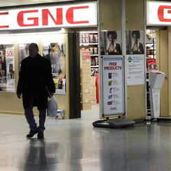 A man leaves a GNC store, Tuesday, Feb. 3, 2015 in New York. Numerous store brand supplements aren"™t what their labels claim to be, an ongoing investigation of popular herbal supplements subjected to DNA testing has found, New York Attorney General Eric Schneiderman said Tuesday.
