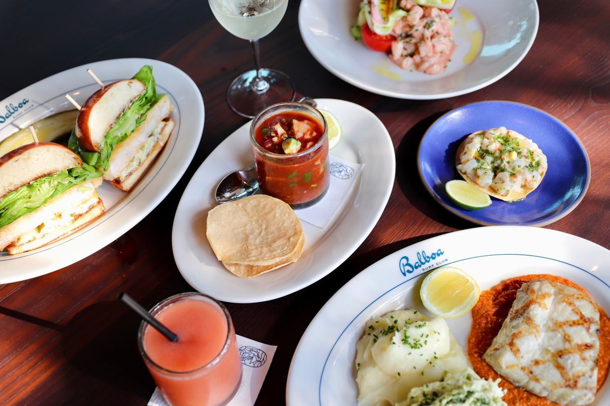 A Balboa Surf Club spread, with a fish filet served with mashed potatoes, seafood cocktail served with tostadas, a tuna burger, and halibut tostada.