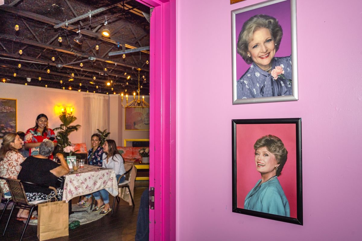 Two framed photographs of Betty White and Rue McClanahan&nbsp;from “Golden Girls” on a pink restaurant wall.