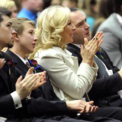 Nanette Wride along with her sons, from left, Shea Wride, Tyesun Wride and Nathan Mohler applaud the news that Utah County sheriff's deputy Greg Sherwood had surgery earlier in the day to remove the remnants of his gunshot wound during the funeral service for her late husband, Utah County Sheriff's Sgt. Cory Wride, at the UCCU Events Center in Orem on Wednesday, Feb. 5, 2014.