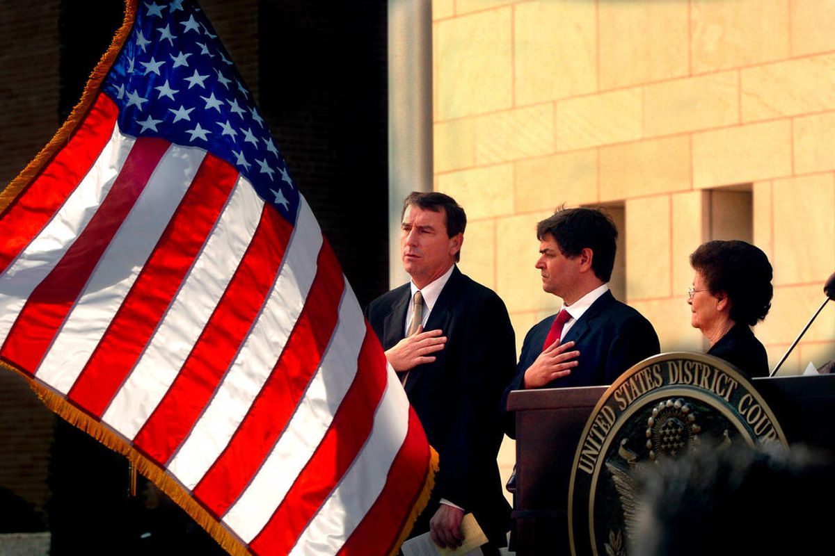 In this Nov. 14, 2005, file photo, U.S. Southern District Judge Andrew S. Hanen, left, joins with Filemon B. Vela, Jr. and Blanca Vela for the Pledge of Allegiance during the United States Courthouse naming ceremony in Brownsville, Texas. Hanen temporaril