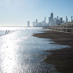 Ice forms on the lakefront trail as steam rises from buildings that make up the Chicago skyline. Temperatures dipped to -1 °F this morning, marking the first sub-zero temperature of the season, according to the National Weather Service Chicago, Friday morning, Jan. 7, 2021.