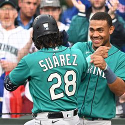APRIL 11: Julio Rodriguez #44 and Eugenio Suarez #28 of the Seattle Mariners celebrate after the two run home run in the first inning against the Chicago Cubs at Wrigley Field on April 11, 2023 in Chicago, Illinois.